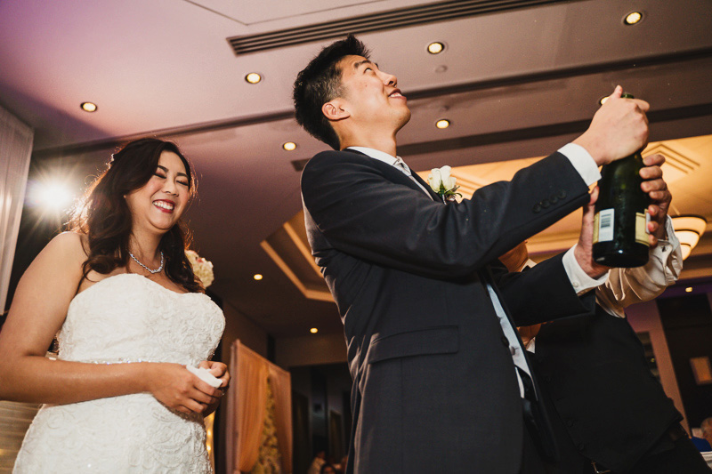 Hilton Markham Toronto Wedding Photographer popping champagne